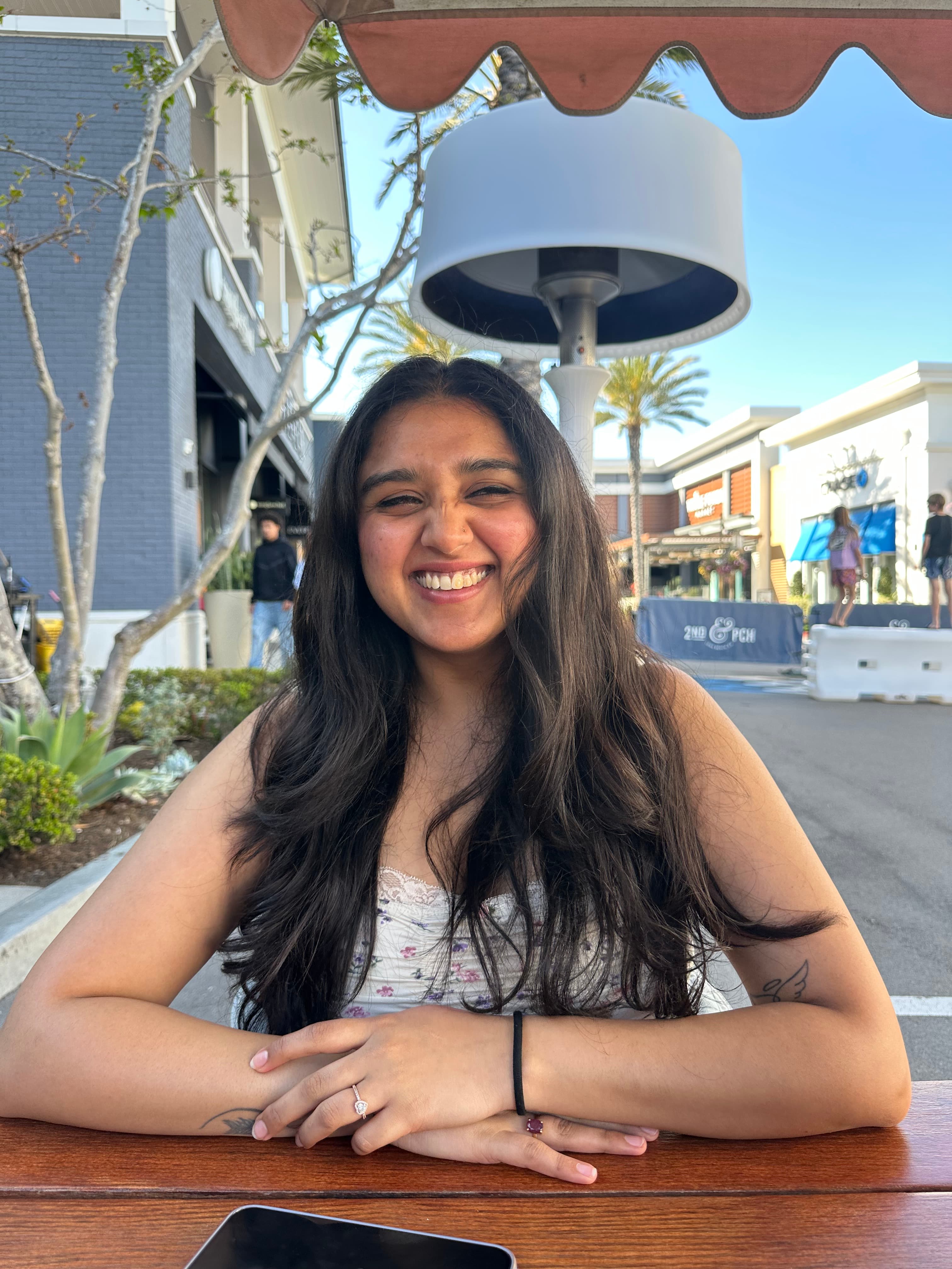 Kashish Datta smiling at an outdoor table